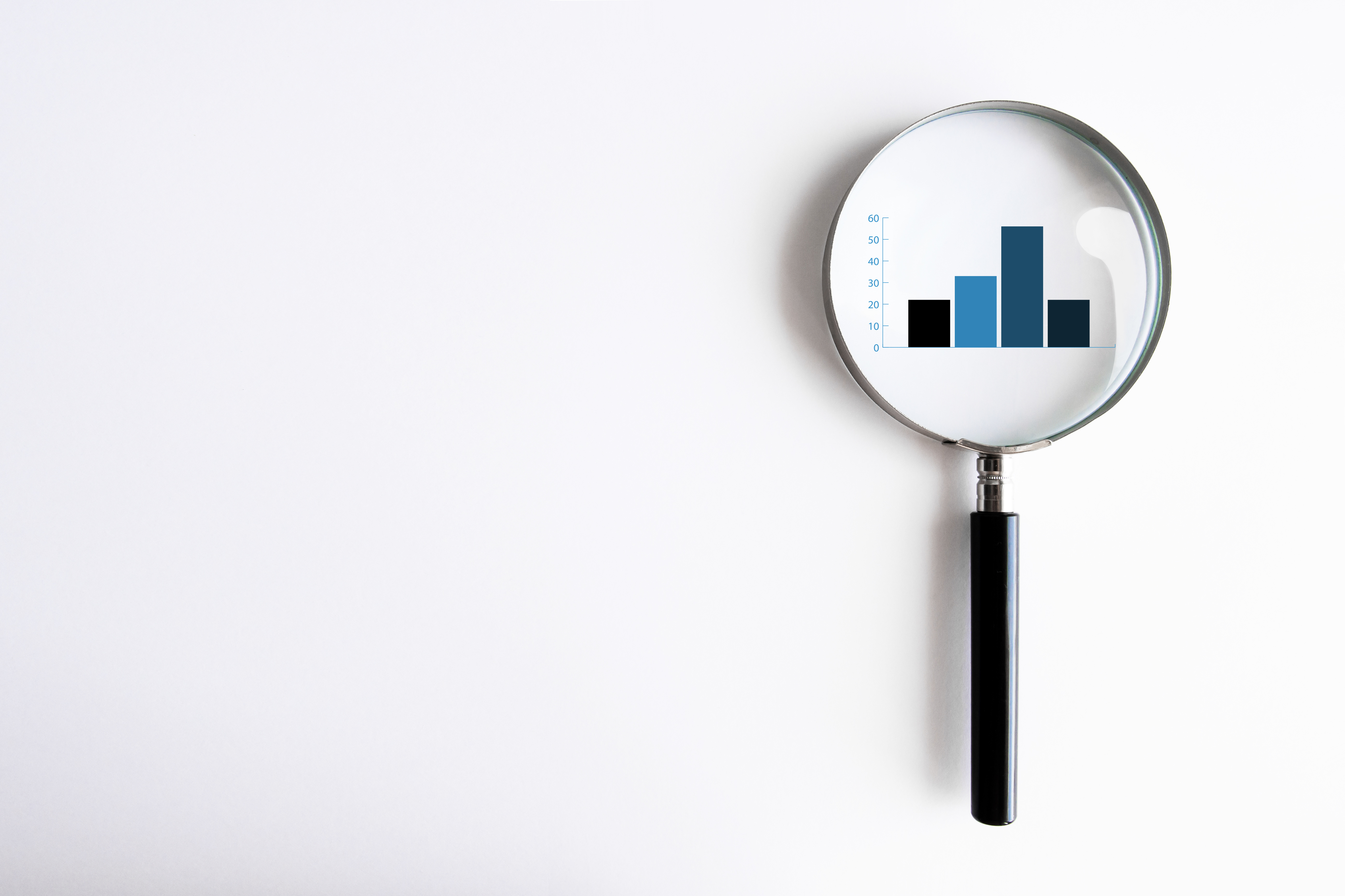magnifying glass over bar graph