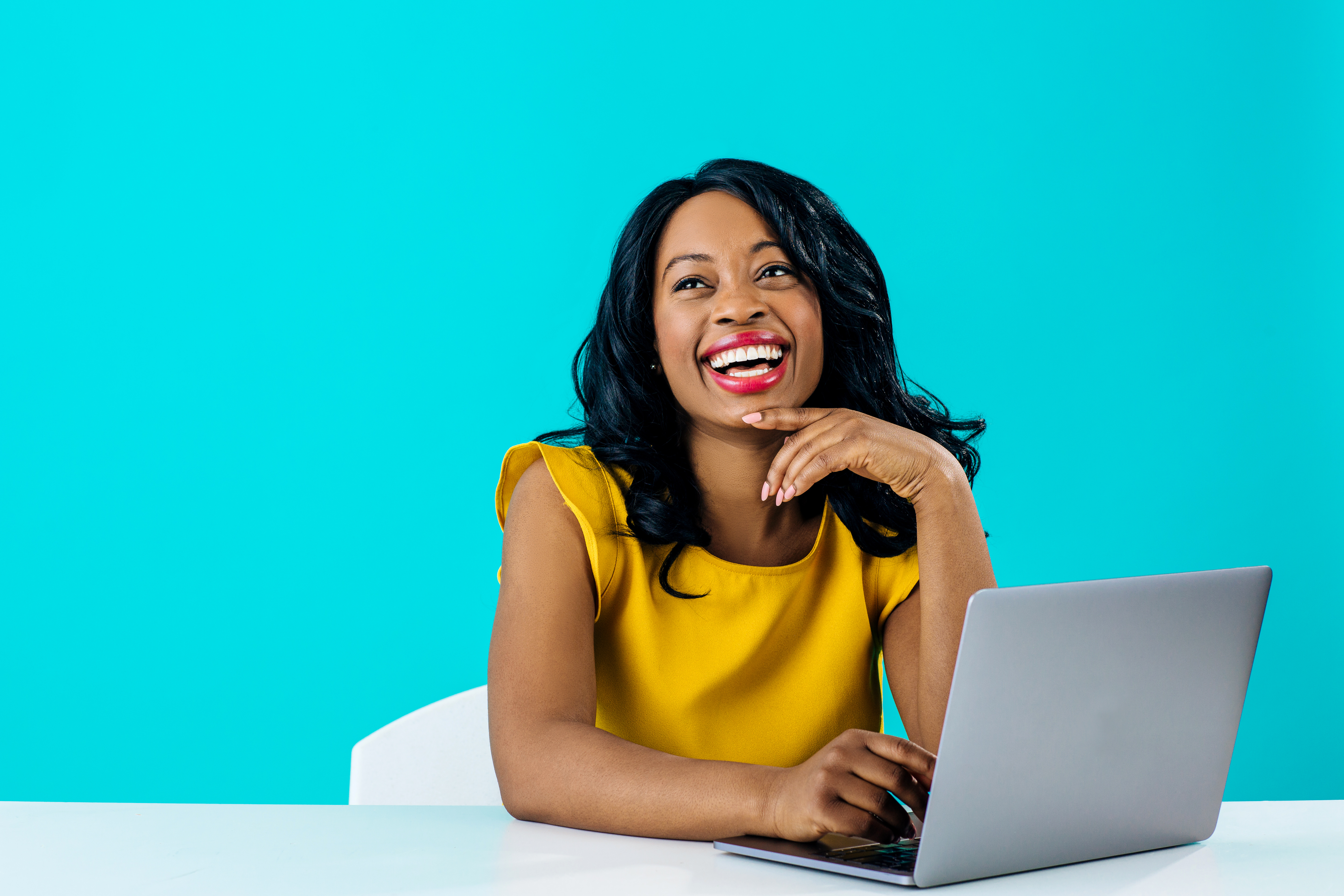 woman sitting at computer smiling