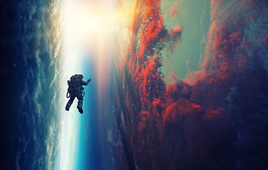 Astronaut flying by sky full of colorful clouds.