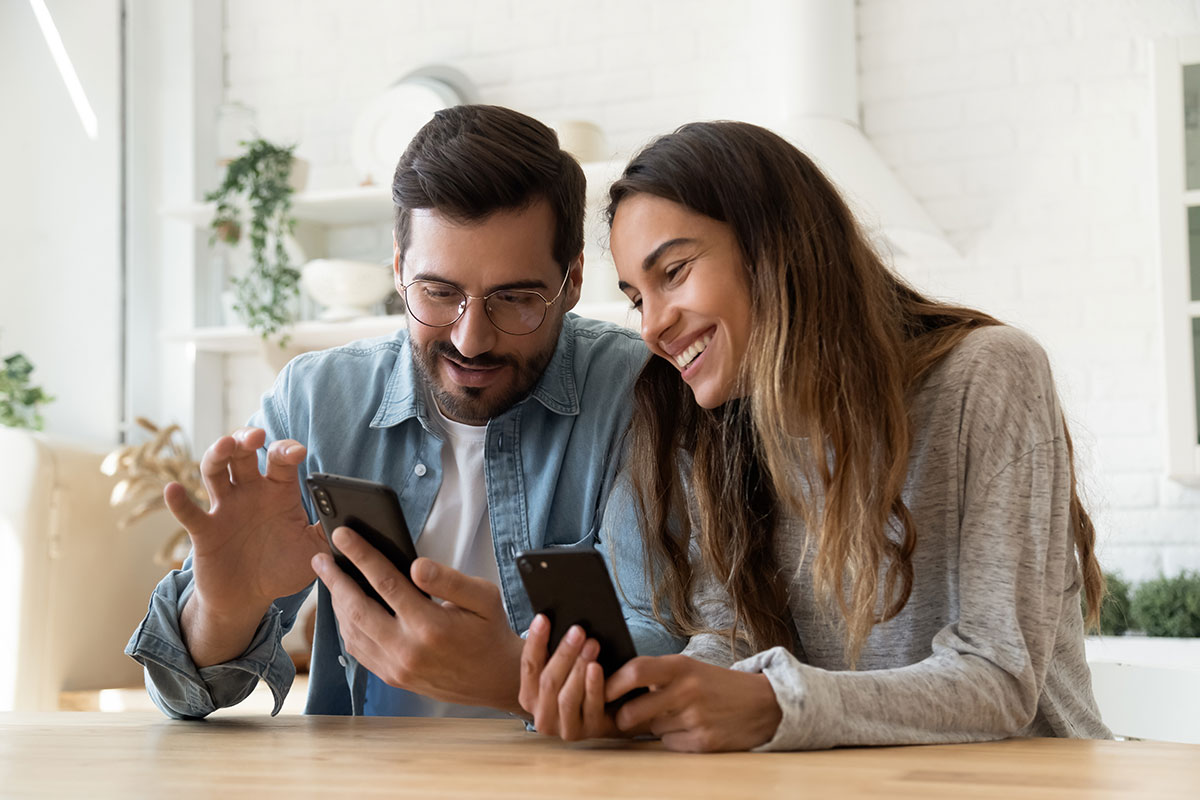 Man and woman looking at a handheld device.