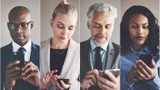 Four people looking at their smartphones.
