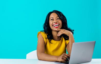 woman sitting at computer smiling