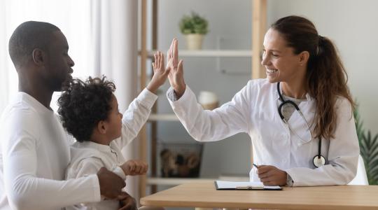 Doctor with patient and family, giving high five