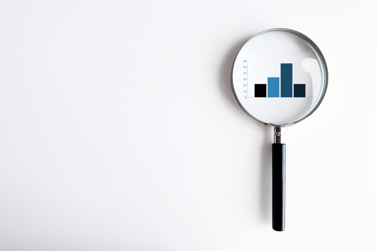 magnifying glass over bar graph
