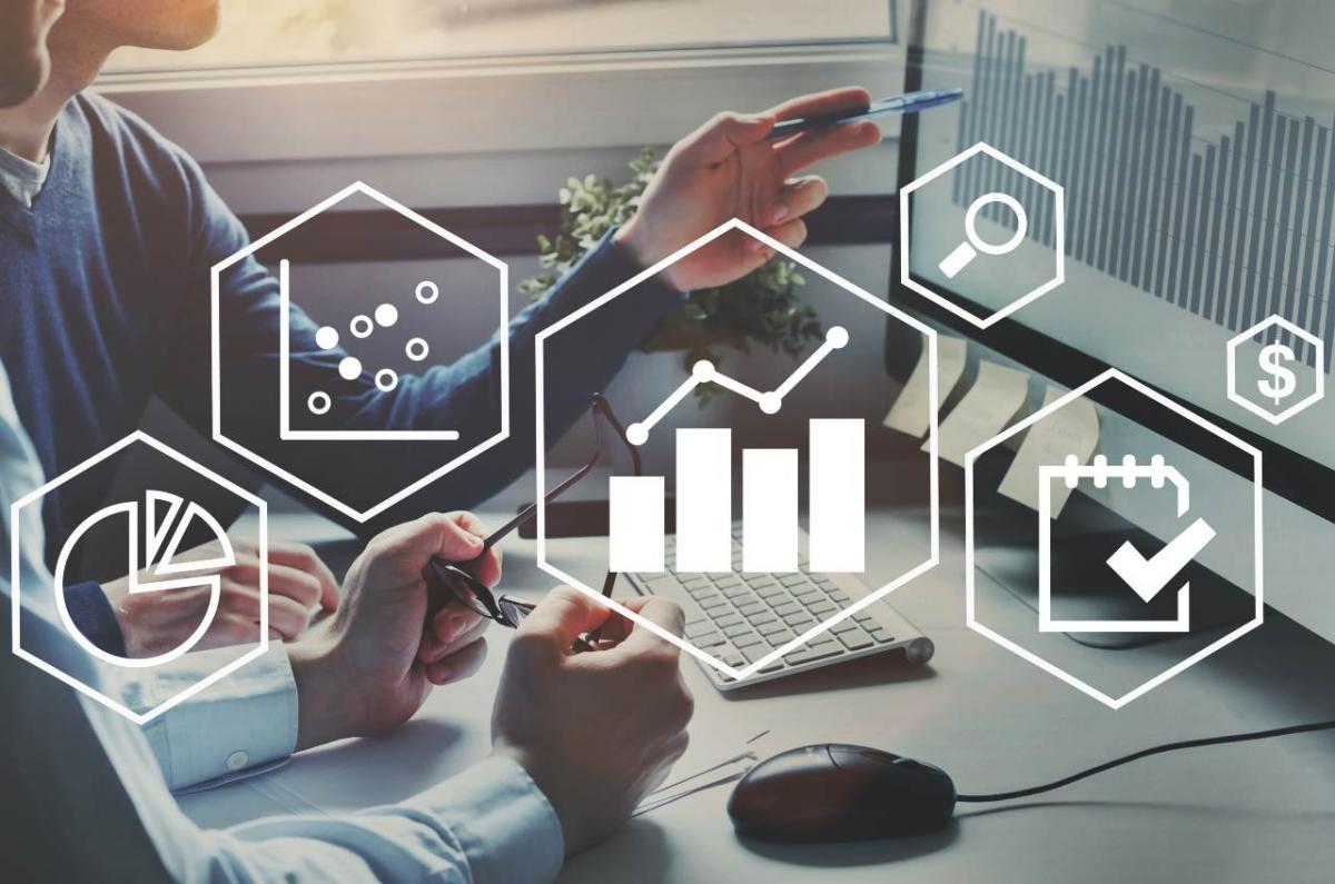 Two people point at computer screen with overlayed data management icons.
